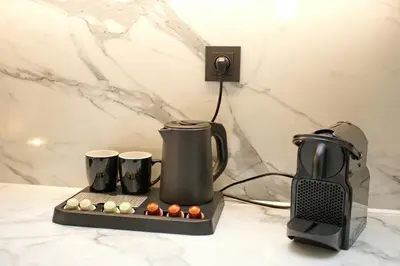 a coffee maker and coffee cups on a counter at Blisséa in Piraeus