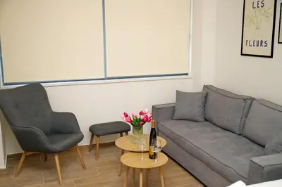 a living room with a couch and two chairs and a table at Blisséa in Piraeus