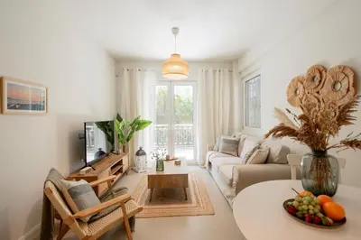 a living room with a couch and a table at Vouliagmeni Suite 1 by Anothr in Athens
