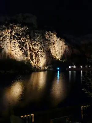 a night view of a lake with a cliff at Vouliagmeni Suite 1 by Anothr in Athens