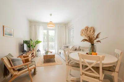 a living room with a white table and chairs at Vouliagmeni Suite 1 by Anothr in Athens