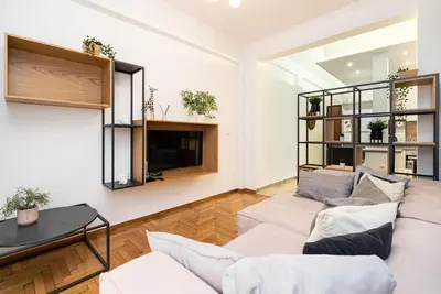 a living room with a couch and a tv at Athens Casa All Acropolis in Athens