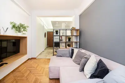 a living room with a white couch and a fireplace at Athens Casa All Acropolis in Athens