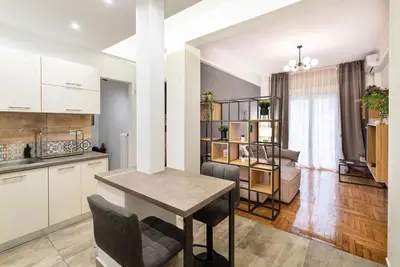 a kitchen and living room with a table and chairs at Athens Casa All Acropolis in Athens