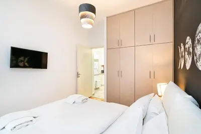 a bedroom with a bed with white sheets at Athens Casa All Acropolis in Athens