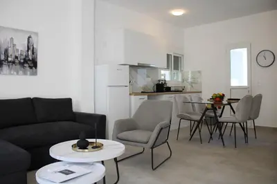 a living room with a couch and chairs and a table at ARIS Urban Gazi in Athens