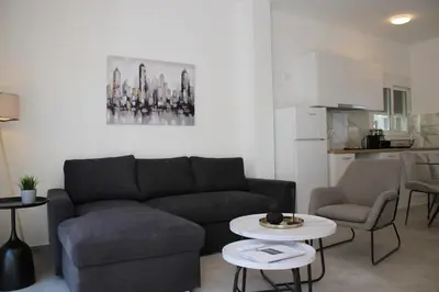 a living room with a couch and a table at ARIS Urban Gazi in Athens
