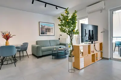 a living room with a couch and a tv at Premium Stay at a Stunning Residence in Athens