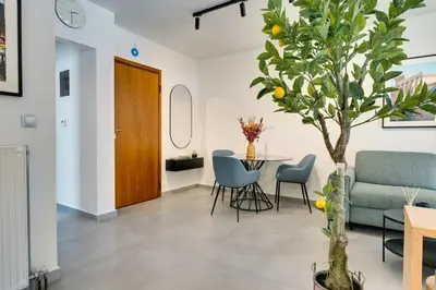 a living room with a table and a tree at Premium Stay at a Stunning Residence in Athens