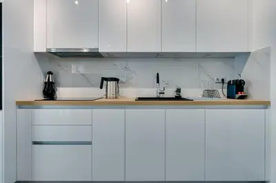 a kitchen with white cabinets and a counter top at Premium Stay at a Stunning Residence in Athens