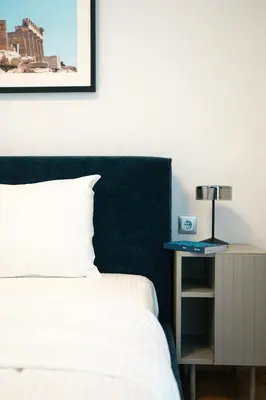 a bedroom with a bed and a table with a lamp at Premium Stay at a Stunning Residence in Athens