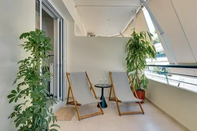 two chairs and a table in a room with plants at Premium Stay at a Stunning Residence in Athens