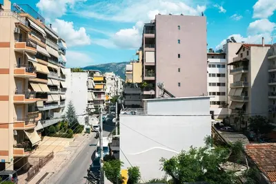 an empty street in a city with tall buildings at Premium Stay at a Stunning Residence in Athens