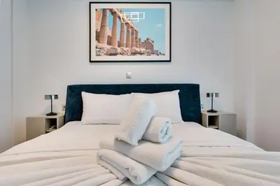 a bedroom with a bed with towels on it at Premium Stay at a Stunning Residence in Athens