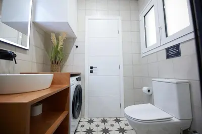 a bathroom with a toilet and a sink at ARIS Ampelokipoi retreat in Athens