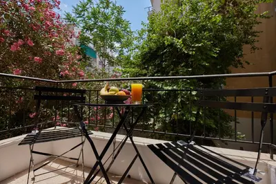 a bowl of fruit on a table on a balcony at ARIS Ampelokipoi retreat in Athens