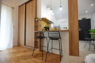 a kitchen with three bar stools at a counter at ARIS Ampelokipoi retreat in Athens