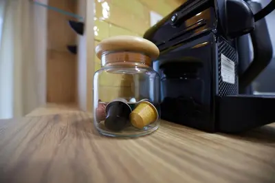a glass jar sitting on a table next to a microwave at ARIS Ampelokipoi retreat in Athens