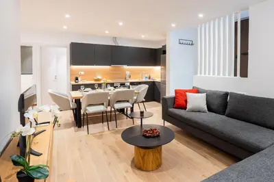 a living room with a couch and a table at Exclusive 3-Bedroom Haven in Kolonaki Center in Athens