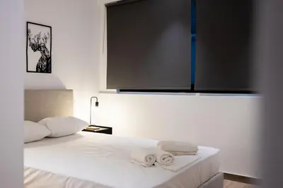 a bedroom with a bed with towels on it at Exclusive 3-Bedroom Haven in Kolonaki Center in Athens