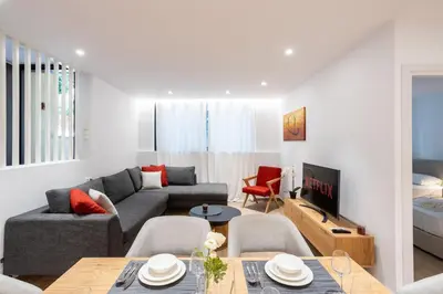 a living room with a couch and a table at Exclusive 3-Bedroom Haven in Kolonaki Center in Athens