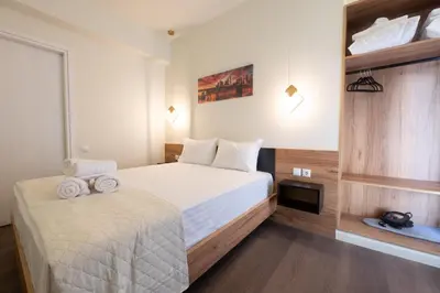 a hotel room with a bed and a tv at Modern Rooms Exarchia in Athens