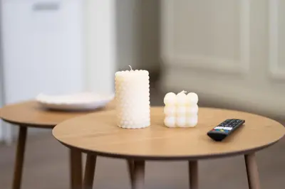 a small table with a candle and a remote control at Modern Rooms Exarchia in Athens