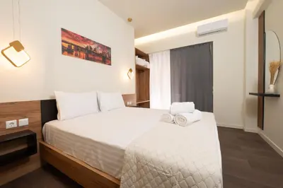 a bedroom with a bed with towels on it at Modern Rooms Exarchia in Athens