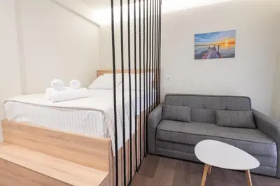 a small bedroom with a bed and a couch at Modern Rooms Exarchia in Athens