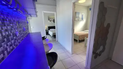 a kitchen with a purple counter and a room with a bedroom at Spacious Modern apartment in Palaiá Fókaia