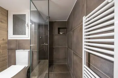 a bathroom with a toilet and a walk in shower at Modern Apartment - Balcony & Metro Access in Athens