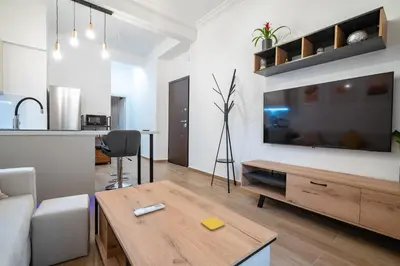 a living room with a large flat screen tv on a wall at Zeus Nest for 4 pers by ΜΡS in Athens