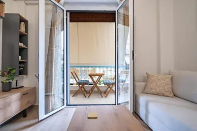 a living room with a sliding glass door leading to a patio at Zeus Nest for 4 pers by ΜΡS in Athens