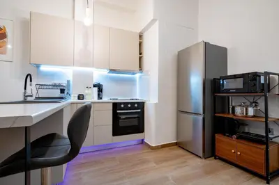 a kitchen with a stainless steel refrigerator and a sink at Zeus Nest for 4 pers by ΜΡS in Athens
