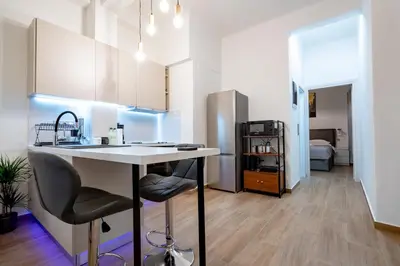 a kitchen with a table and chairs in a room at Zeus Nest for 4 pers by ΜΡS in Athens