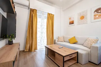 a living room with a couch and a table at Zeus Nest for 4 pers by ΜΡS in Athens
