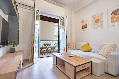 a living room with a couch and a table at Zeus Nest for 4 pers by ΜΡS in Athens