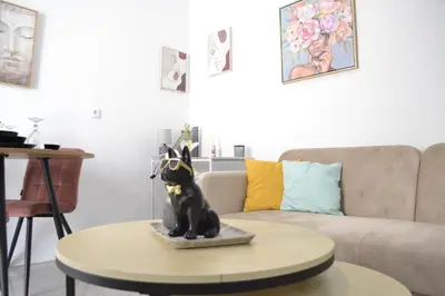 a living room with a dog statue on a table at AIOLOS near metro Apartment in ALIMOS in Athens