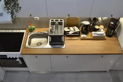 a kitchen counter with a sink and a microwave at AIOLOS near metro Apartment in ALIMOS in Athens