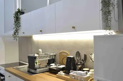a kitchen with a dish drying rack on a counter at AIOLOS near metro Apartment in ALIMOS in Athens