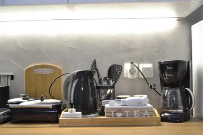 a kitchen counter with two coffee makers on it at AIOLOS near metro Apartment in ALIMOS in Athens