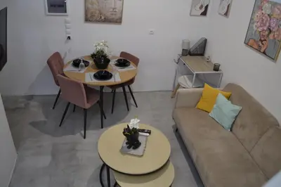 a living room with a couch and a table at AIOLOS near metro Apartment in ALIMOS in Athens