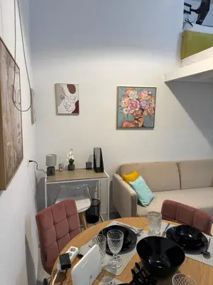 a living room with a table and a couch at AIOLOS near metro Apartment in ALIMOS in Athens