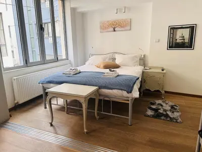 a bedroom with a bed and a table in it at Urban Apartment At Monastiraki Sq - Psiri in Athens