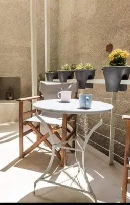 a white table with two cups on top of it at Urban Apartment At Monastiraki Sq - Psiri in Athens