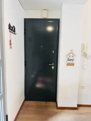 a black door in the corner of a room at Urban Apartment At Monastiraki Sq - Psiri in Athens