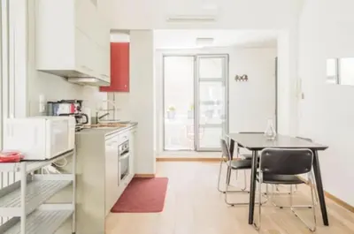 a kitchen with a table and chairs in a room at Urban Apartment At Monastiraki Sq - Psiri in Athens