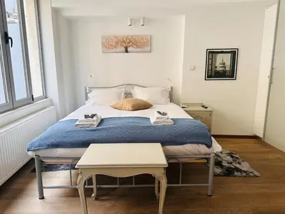 a bedroom with a bed with a blue blanket at Urban Apartment At Monastiraki Sq - Psiri in Athens