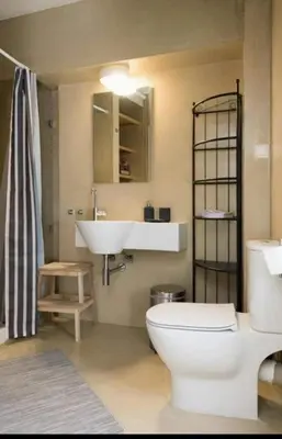 a bathroom with a white toilet and a sink at Urban Apartment At Monastiraki Sq - Psiri in Athens