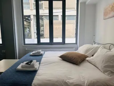 a bed with towels on it with a window at Urban Apartment At Monastiraki Sq - Psiri in Athens